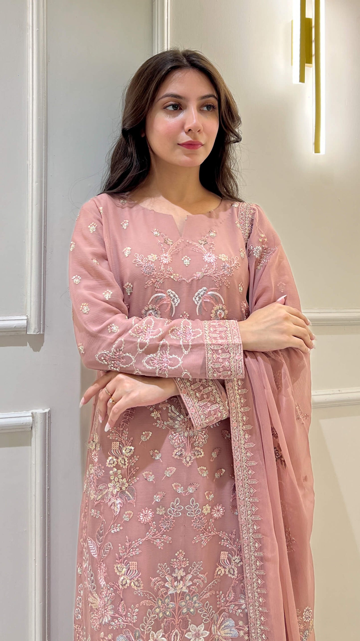 Close-up of floral embroidery on tea pink shirt