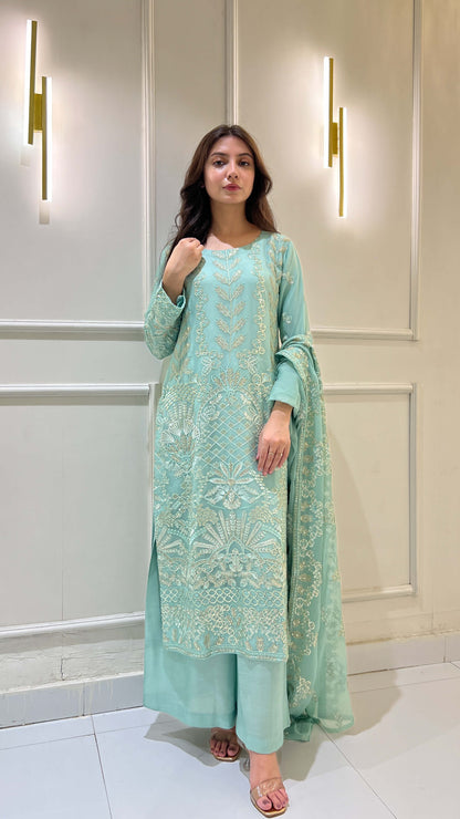 Model posing in light blue chiffon embroidered 3-piece suit