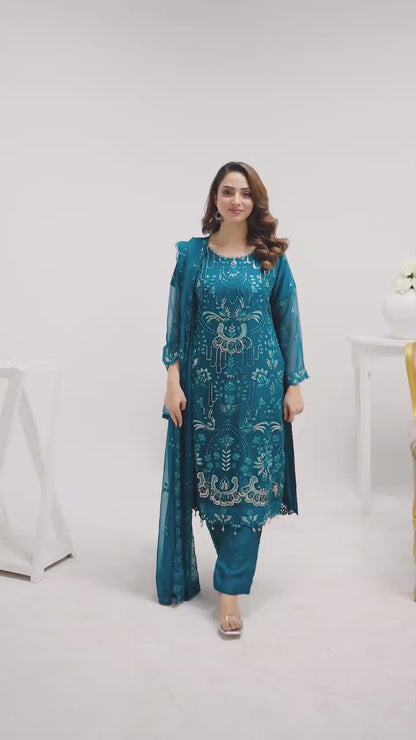 Model wearing blue embroidered chiffon shalwar kameez, walking and turning to showcase embroidery and fabric movement with dupatta styling.